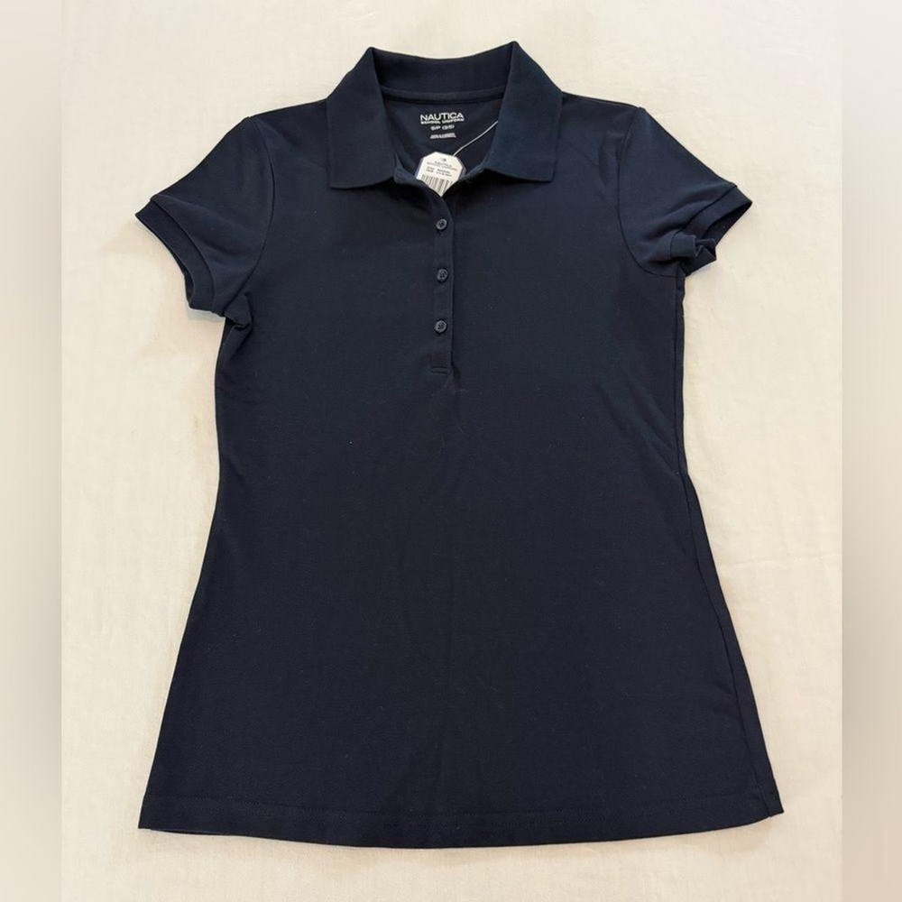 Nautica School Uniform women's polo shirt in classic navy blue. Features a co...
